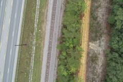 Aerial view of road, railroad tracks, clay road, and entrance to Red Hill Cemetery